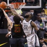 
              Oregon center Franck Kepnang (22) blocks a shot from Southern California forward Max Agbonkpolo (23) during the first half of an NCAA college basketball game in Eugene, Ore., Saturday, Feb. 26, 2022. (AP Photo/Thomas Boyd)
            