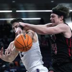 
              Rutgers guard Paul Mulcahy, right, vies for a rebound against Northwestern guard Ryan Greer during the first half of an NCAA college basketball game in Evanston, Ill., Tuesday, Feb. 1, 2022. (AP Photo/Nam Y. Huh)
            