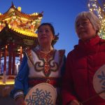 
              Liu Jingyun, 69, right, speaks during an interview with the Associated Press, with another performer Qiao Yanzhen by her side at a Winter Olympics Culture Plaza in the western district of Shijingshan in Beijing on Friday, Feb. 4, 2022. “I'm very excited,” said Liu, who was part of a group of performers at a kickoff celebration for the Olympics in western Beijing. “I hope that that our athletes perform well, and together show the world our future." (AP Photo/Sam McNeil)
            