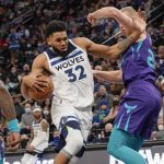 
              Minnesota Timberwolves center Karl-Anthony Towns (32) pushes past Charlotte Hornets center Mason Plumlee during the first half of an NBA basketball game Tuesday, Feb. 15, 2022, in Minneapolis. (AP Photo/Craig Lassig)
            