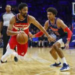 
              Washington Wizards' Spencer Dinwiddie, left, drives to the basket against Philadelphia 76ers' Matisse Thybulle, right, during the first half of an NBA basketball game, Wednesday, Feb. 2, 2022, in Philadelphia. (AP Photo/Chris Szagola)
            