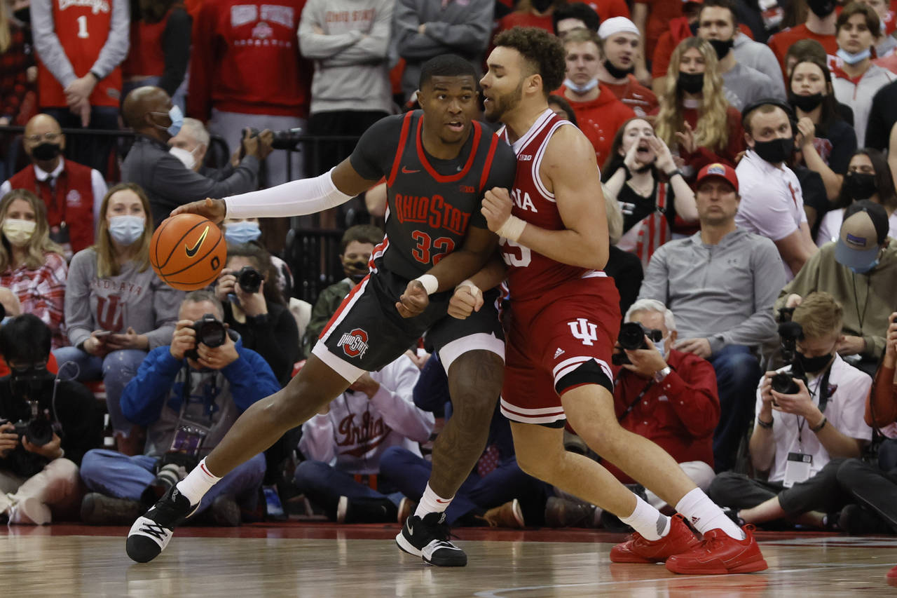 Ohio State's E.J. Liddell, left, posts up against Indiana's Race Thompson during the first half of ...