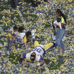 
              Los Angeles Rams defensive end Aaron Donald (99) celebrates with his family after his team won the NFL Super Bowl 56 football game against the Cincinnati Bengals,Sunday, Feb. 13, 2022, in Inglewood, Calif. (AP Photo/Morry Gash)
            