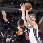 
              Sacramento Kings' Domantas Sabonis shoots over Chicago Bulls' Nikola Vucevic during the first half of an NBA basketball game Wednesday, Feb. 16, 2022, in Chicago. (AP Photo/Charles Rex Arbogast)
            