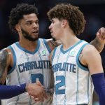 
              Charlotte Hornets forward Miles Bridges (0) congratulates guard LaMelo Ball (2) at the end of the first half of the team's NBA basketball game against the Toronto Raptors in Charlotte, N.C., Friday, Feb. 25, 2022. (AP Photo/Jacob Kupferman)
            