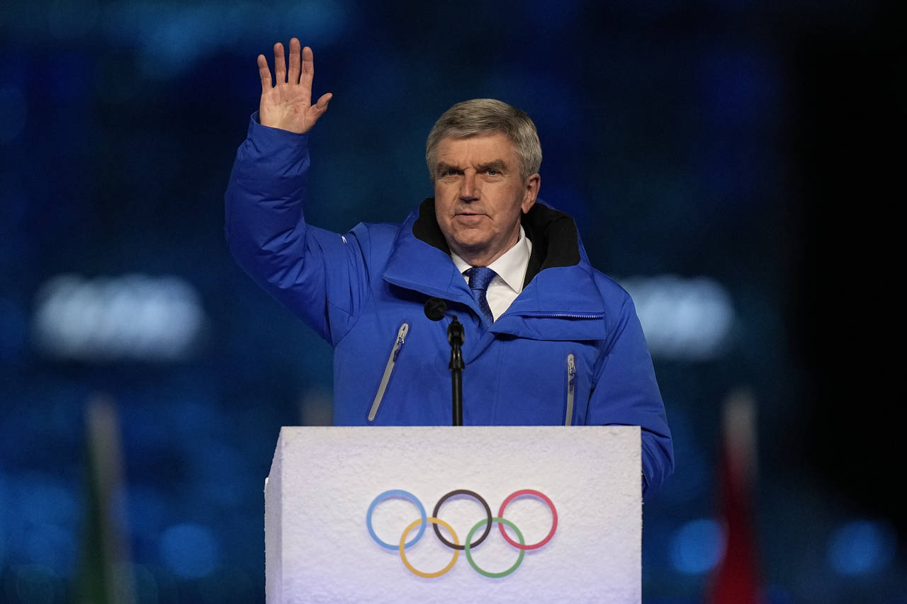 International Olympic Committee President Thomas Bach waves during the closing ceremony of the 2022...