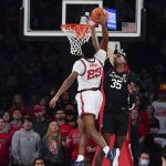 
              Connecticut's Samson Johnson, right, tries to block a shot by St. John's Montez Mathis during the first half of an NCAA college basketball game Sunday, Feb. 13, 2022, in New York. (AP Photo/Seth Wenig)
            