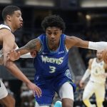 
              Minnesota Timberwolves' Jaden McDaniels (3) goes to the basket against Indiana Pacers' Tyrese Haliburton, left, during the first half of an NBA basketball game, Sunday, Feb. 13, 2022, in Indianapolis. (AP Photo/Darron Cummings)
            