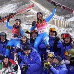 
              Sofia Goggia, of Italy, silver, top left, and Nadia Delago, of Italy, bronze, celebrate on the shoulders of teammates after the medal ceremony for the women's downhill at the 2022 Winter Olympics, Tuesday, Feb. 15, 2022, in the Yanqing district of Beijing. (AP Photo/Luca Bruno)
            