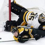 
              Boston Bruins center Oskar Steen, bottom, collides with Pittsburgh Penguins goaltender Tristan Jarry (35) during the second period of an NHL hockey game, Tuesday, Feb. 8, 2022. (AP Photo/Charles Krupa)
            