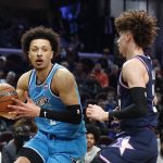 
              Team Barry's Cade Cunningham, of the Detroit Pistons, drives against Team Payton's LaMelo Ball, of the Charlotte Hornets, during a semifinal of the NBA basketball Rising Stars event, Friday, Feb. 18, 2022, in Cleveland. (AP Photo/Ron Schwane)
            