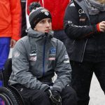 
              FILE - Former ski jumper United States's Nicholas Fairall watches the trial round at a ski jumping tournament in Bischofshofen, Austria, Jan. 5, 2016. Fairall's skis got stuck in sticky snow on a landing in Austria, catapulting him forward with such force that he broke his lower back and it left him in a wheelchair. (AP Photo/Matthias Schrader, File)
            