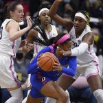 
              Connecticut's Nika Mühl, left, Christyn Williams, back, and Aaliyah Edwards, right, pressure DePaul's Deja Church during the first half of an NCAA college basketball game, Friday, Feb. 11, 2022, in Storrs, Conn. (AP Photo/Jessica Hill)
            