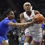 
              Connecticut's Aaliyah Edwards, right, is guarded by DePaul's Darrione Rogers, left, in the first half of an NCAA college basketball game, Friday, Feb. 11, 2022, in Storrs, Conn. (AP Photo/Jessica Hill)
            