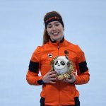 
              Antoinette de Jong of the Netherlands reacts during a flower ceremony after winning the bronze medal in the women's speedskating 1,500-meter race at the 2022 Winter Olympics, Monday, Feb. 7, 2022, in Beijing. (AP Photo/Ashley Landis)
            