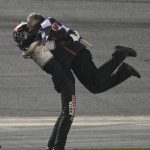 
              Austin Cindric, left, gets a hug from one of his crew members after he won the NASCAR Daytona 500 auto race at Daytona International Speedway, Sunday, Feb. 20, 2022, in Daytona Beach, Fla. (AP Photo/Phelan M. Ebenhack)
            