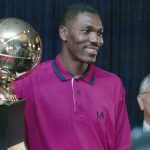 
              FILE - Hakeem Olajuwon poses with his trophy after being named the NBA's Most Valuable Player in Houston, June 23, 1994. (AP Photo/David J. Phillip, File)
            