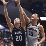 
              Villanova's Maddy Siegrist (20) and Connecticut's Nika Mühl (10) reach for a rebound in the first half of an NCAA college basketball game, Wednesday, Feb. 9, 2022, in Hartford, Conn. (AP Photo/Jessica Hill)
            