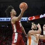 
              Arkansas forward Jaylin Williams (10) drives past Tennessee forward Uros Plavsic (33) during the first half of an NCAA college basketball game Saturday, Feb. 19, 2022, in Fayetteville, Ark. (AP Photo/Michael Woods)
            