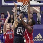 Washington's Terrell Brown Jr. shoots with Arizona's Azuolas Tubelis (10) and Christian Koloko defending during the first half of an NCAA college basketball game Saturday, Feb. 12, 2022, in Seattle. (AP Photo/John Froschauer)