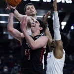 
              Rutgers guard Paul Mulcahy (4) drives to the basket against Northwestern guard Julian Roper II., right, and forward Robbie Beran during the first half of an NCAA college basketball game in Evanston, Ill., Tuesday, Feb. 1, 2022. (AP Photo/Nam Y. Huh)
            