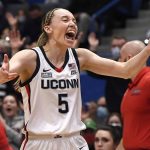 
              Connecticut's Paige Bueckers reacts after making her first basket after coming back from being injured, in the first half of an NCAA college basketball game against St. John's, Friday, Feb. 25, 2022, in Hartford, Conn. (AP Photo/Jessica Hill)
            