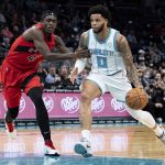 
              Charlotte Hornets forward Miles Bridges (0) drives to the basket while guarded by Toronto Raptors forward Pascal Siakam (43) during the first half of an NBA basketball game in Charlotte, N.C., Monday, Feb. 7, 2022. (AP Photo/Jacob Kupferman)
            