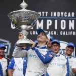 
              FILE  -NTT IndyCar Series winner Alex Palou, center, celebrates with the trophy after taking 4th place in an IndyCar auto race at the Grand Prix of Long Beach, Sunday, Sept. 26, 2021, in Long Beach, Calif. The stars of IndyCar crowded into Indianapolis Motor Speedway to celebrate an upcoming season of opportunity for America's open-wheel racing series to reestablish its legitimacy and expand its popularity. The party was held just one week before IndyCar's drivers hit the streets of St. Petersburg for the first practice session of the season. (AP Photo/Alex Gallardo, File)
            