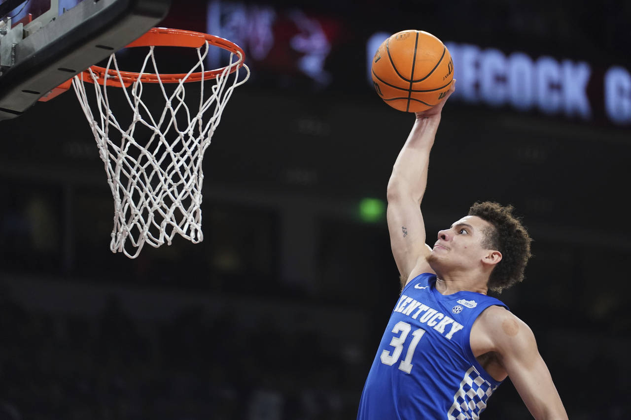 Kentucky guard Kellan Grady goes up for a dunk during the first half against South Carolina in an N...