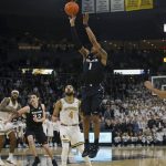 
              Xavier's Paul Scruggs (1) makes a three point shot at the end of the second overtime to send an NCAA college basketball game against Providence into triple overtime Wednesday, Feb. 23, 2022, in Providence, R.I. (AP Photo/Stew Milne)
            