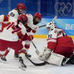 
              Denmark goalkeeper Cassandra Repstock-Romme (72) defends against a rush by China's Mulan Kang (17) during a preliminary round women's hockey game at the 2022 Winter Olympics, Friday, Feb. 4, 2022, in Beijing. (AP Photo/Petr David Josek)
            
