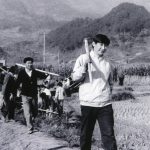 
              FILE - A 1988 photo provided by China's Xinhua News Agency shows Communist Party Leader Xi Jinping, right, then secretary of the Ningde Prefecture Committee of the Communist Party of China (CPC), participates in farm work during his investigation in the countryside. Born in Beijing in 1953, Xi enjoyed a privileged youth as the second son of Xi Zhongxun, a former vice premier and guerrilla commander in the civil war that brought Mao Zedong's communist rebels to power in 1949. At 15, Xi Jinping was sent to rural Shaanxi province in 1969 as part of Mao's campaign to have educated urban young people learn from peasants. (AP Photo/Xinhua, File)
            