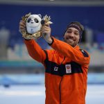 
              Kjeld Nuis of the Netherlands celebrates his gold medal and Olympic record during a venue ceremony for the men's speedskating 1,500-meter race at the 2022 Winter Olympics, Tuesday, Feb. 8, 2022, in Beijing. (AP Photo/Ashley Landis)
            