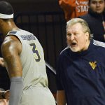 
              West Virginia head coach Bob Huggins yells at forward Gabe Osabuohien (3) following his accumulation of a pair of technical fouls during the second half of an NCAA college basketball game against Oklahoma State, Saturday, Feb. 12, 2022, in Stillwater, Okla. Oklahoma State won 81-58. (AP Photo/Brody Schmidt)
            