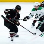 
              Dallas Stars center Tyler Seguin (91) battles with Arizona Coyotes defenseman Shayne Gostisbehere (14) for the puck during the first period of an NHL hockey game Sunday, Feb. 20, 2022, in Glendale, Ariz. (AP Photo/Ross D. Franklin)
            