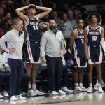 Gonzaga coach Mark Few, standing at left, reacts to a call with Chet Holmgren (34), Nolan Hickman (11) and Hunter Sallis (10) during the second half of the team's NCAA college basketball game against Saint Mary's in Moraga, Calif., Saturday, Feb. 26, 2022. (AP Photo/Jeff Chiu)