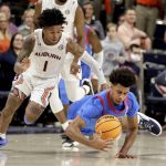
              Mississippi forward Jaemyn Brakefield (4) dives for a loose ball as Auburn guard Wendell Green Jr. (1) guards him during the second half of an NCAA college basketball game Wednesday, Feb. 23, 2022, in Auburn, Ala. (AP Photo/Butch Dill)
            