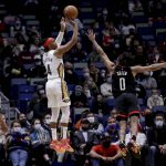 
              New Orleans Pelicans guard Devonte' Graham (4) shoots over Houston Rockets guard Jalen Green (0) during the second quarter of an NBA basketball game in New Orleans, Tuesday, Feb. 8, 2022. (AP Photo/Derick Hingle)
            