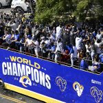 
              A bus carrying Los Angeles Rams players and coaches drives past fans during the team's victory parade in Los Angeles, Wednesday, Feb. 16, 2022, following their win Sunday over the Cincinnati Bengals in the NFL Super Bowl 56 football game. (AP Photo/Kyusung Gong)
            