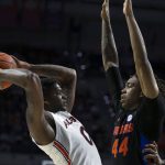 
              Auburn guard K.D. Johnson (0) tries to shoot around Florida guard Niels Lane (44) during the first half of an NCAA college basketball game Saturday, Feb. 19, 2022, in Gainesville, Fla. (AP Photo/Alan Youngblood)
            