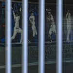 
              CORRECTS THAT THE LOCKOUT NOW EXTENDED TO 77 DAYS, NOT 76 AS ORIGINALLY SENT -  A mural of players adorns a wall behind a locked gate on the day pitchers and catcher were scheduled to report to camp at the New York Yankees spring training complex at George M. Steinbrenner Field Wednesday, Feb. 16, 2022, in Tampa, Fla. The usual spring training buzz is missing because of a lockout that’s now extended to 77 days and become the second-longest work stoppage in baseball history. (AP Photo/Steve Nesius)
            