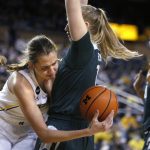
              Michigan center Izabel Varejao, left, tries to pass the ball around Michigan State guard Matilda Ekh during the first half of an NCAA college basketball game Thursday, Feb. 24, 2022, in Ann Arbor, Mich. (AP Photo/Duane Burleson)
            