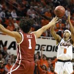 
              Oklahoma State guard Avery Anderson III (0) shoots over Oklahoma forward Jalen Hill (1) in the first half of an NCAA college basketball game Saturday, Feb. 5, 2022, in Stillwater, Okla. (AP Photo/Brody Schmidt)
            