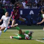 
              New Zealand goalkeeper Erin Nayler, second from right, makes a saves as United States forward Margaret Purce, second from left, leaps over her while defender Ali Riley, left, and defender Claudia Bunge watch during the first half of the 2022 SheBelieves Cup soccer match Sunday, Feb. 20, 2022, in Carson, Calif. (AP Photo/Mark J. Terrill)
            