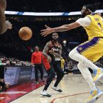 
              Portland Trail Blazers forward Keljin Blevins, left, passes the ball as Los Angeles Lakers forward Anthony Davis, right, defends during the first half of an NBA basketball game in Portland, Ore., Wednesday, Feb. 9, 2022. (AP Photo/Steve Dipaola)
            