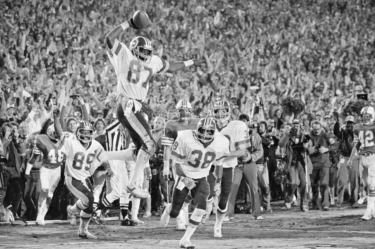 Washington Redskins running back John Riggins (44) hits a stone wall of  Atlanta Falcons as he attempts a run in the game between the Redskins and  the Atlanta Falcons in Washington, Aug.