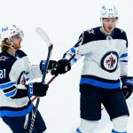 
              Winnipeg Jets left wing Kyle Connor (81) celebrates his empty net goal against the Arizona Coyotes with Jets left wing Evgeny Svechnikov (71) during the third period of an NHL hockey game Sunday, Feb. 27, 2022, in Glendale, Ariz. The Jets won 5-3. (AP Photo/Ross D. Franklin)
            