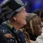 
              Bill Murray, left, and Lil Wayne watch from court side during the first half of the NBA All-Star basketball game, Sunday, Feb. 20, 2022, in Cleveland. (AP Photo/Charles Krupa)
            