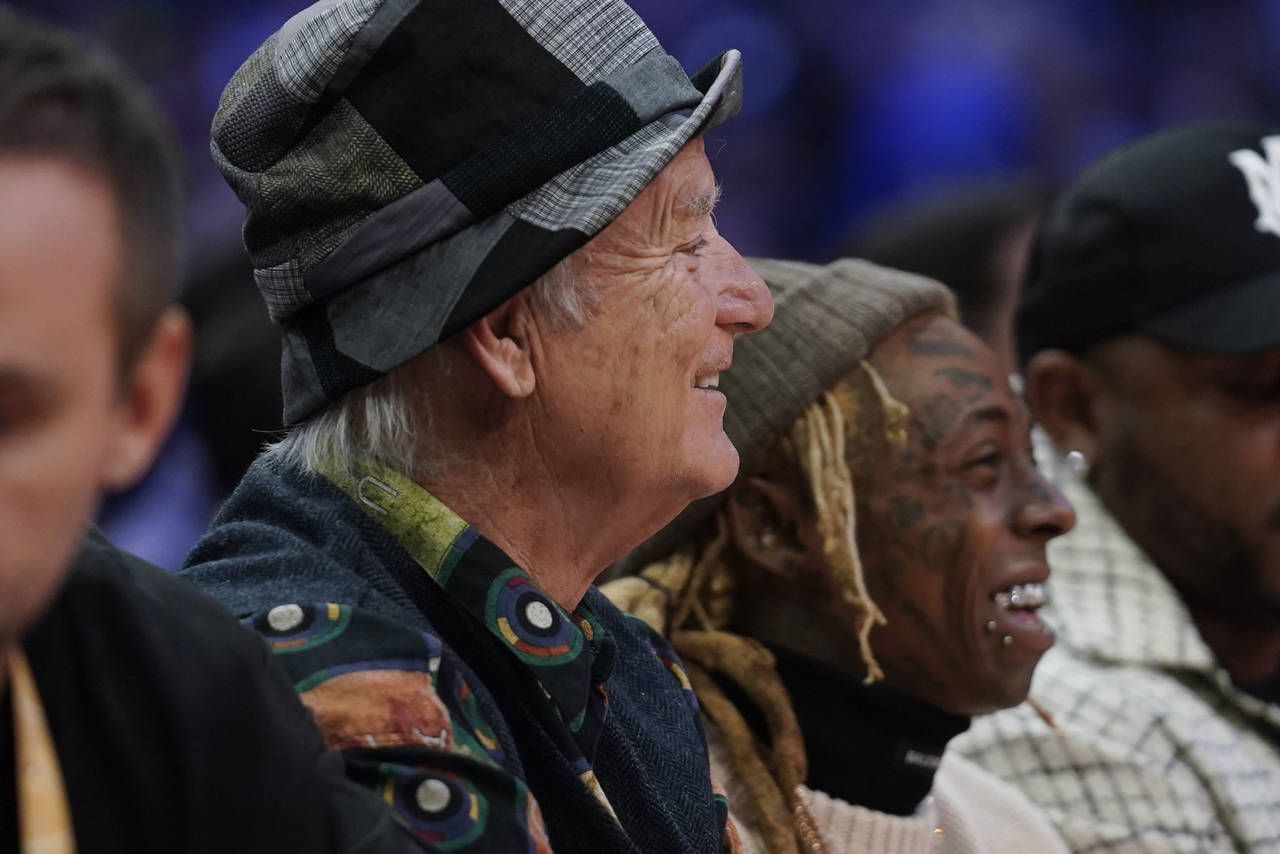 Bill Murray, left, and Lil Wayne watch from court side during the first half of the NBA All-Star ba...