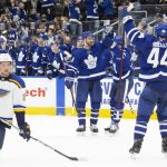 
              Toronto Maple Leafs' TJ Brodie, center, celebrates his goal against the St. Louis Blues during second-period NHL hockey game action in Toronto, Saturday, Feb. 19, 2022. (Chris Young/The Canadian Press via AP)
            